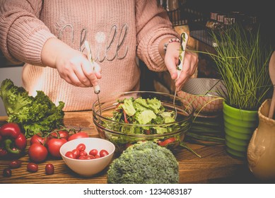 Beautiful plus size woman is making fresh salad in the kitchen - Shutterstock ID 1234083187