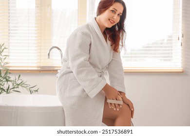 Beautiful plus size woman massaging her leg with anti-cellulite brush in bathroom - Powered by Shutterstock