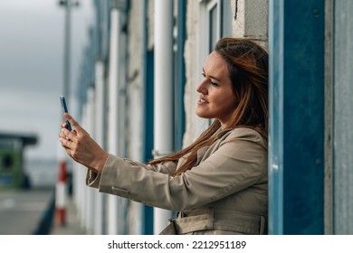 Beautiful Plus Size Woman With Mobile Phone In The Street Taking A Selfie