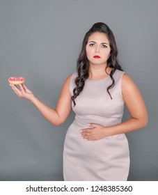 Beautiful Plus Size Woman With Pain In Stomach Holding Donut. Overweight Concept