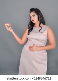 Beautiful Plus Size Woman With Pain In Stomach Holding Donut. Overweight Concept