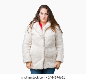 Beautiful Plus Size Young Woman Wearing Winter Sheep Coat Over Isolated Background With Serious Expression On Face. Simple And Natural Looking At The Camera.