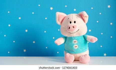 Beautiful Plush Piggy Toy On The White Tabletop In Room