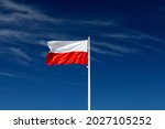 Beautiful Polish flag on a sunny day with blue sky on background