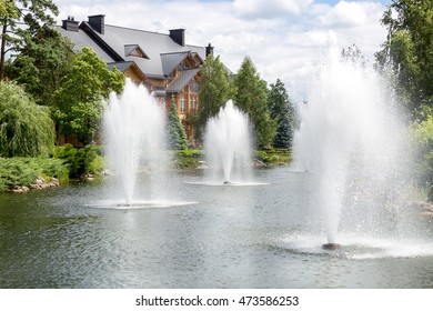 Beautiful Pond With Fountains At Luxurious Mansion