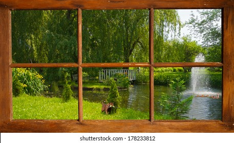 Beautiful pond in the summer, with  a cute lab puppy curiously watching some ducks swimming by, as seen through the cottage window.