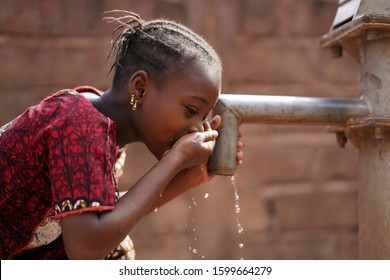 Beautiful Portrait Of African Children Drinking Outdoors Fresh Water From Tap