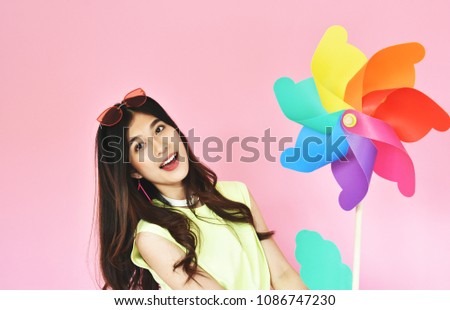 Similar – Young cheerful woman with a gift over her head