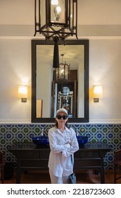 Beautiful Portrait Of An Asian Senior Woman Standing Happy In A Casual Clothing Dress In A Retro Classic Vintage Room. Concept Good Memories For Tourists Relax On Holiday And Vacation.