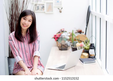 Beautiful Of Portrait Asian Young Woman Working Online On Laptop Sitting At Coffee Shop, Professional Female Freelancer Using Notebook Computer With Connect To Internet For Distance Job.