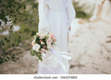 Beautiful portrait of bride with a bouquet in a flying dress