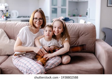 Beautiful Portrait Of A Family With A Disabled Child. Happy Family With A Kid Cerebral Palsy. Lifestyle Moments Of Real Life. Music Rehabilitation. Activities Games Leisure Together. Inclusion Caring