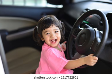 Beautiful Portrait Of Little Asian Child Girl Mixed Race Thai Russia Pakistan Happy Driving And Smile On A Car Concept Safety Family Insurance