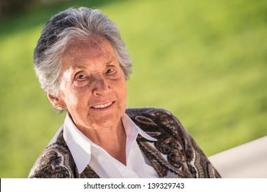 Beautiful Portrait Of A Senior Woman Smiling Outdoors