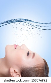 Beautiful portrait of woman with fresh skin in splashes of water , concept for beauty skin care isolated on blue background, asian model