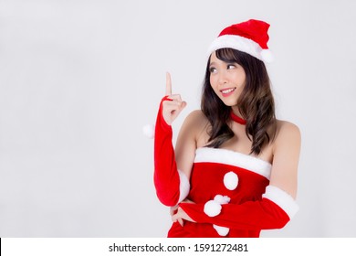 Beautiful portrait young asian woman Santa costume smiling present pointing something in xmas holiday, model asia girl cheerful and happiness celebrating in Christmas isolated on white background. - Powered by Shutterstock