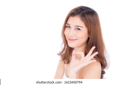 Beautiful portrait young asian woman smiling happy showing ok sign with achievement isolated on white background, asia girl enjoy gesture okay with success and approval.