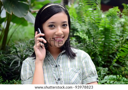 beautiful portrait young teenager girl outdoor make a call