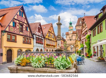 Beautiful postcard view of the famous historic town of Rothenburg ob der Tauber on a sunny day with blue sky and clouds in summer, Franconia, Bavaria, Germany