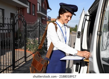 Beautiful Postwoman With Clipboard Near Car