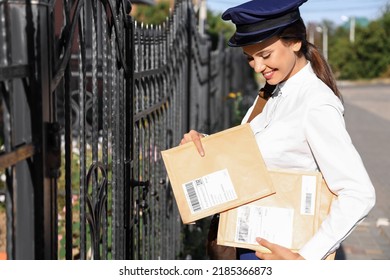 Beautiful Postwoman With Letters Outdoors