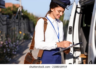 Beautiful Postwoman Writing In Clipboard Near Car