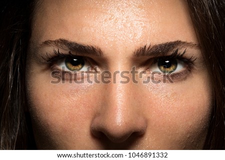 Beautiful and powerful intense staring eyes of confidence and courage in female close up