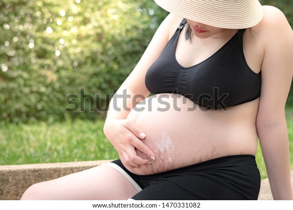 Beautiful Pregnancy Woman Applying Safe Organic Stock Photo