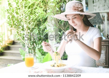 Beautiful pregnant Asian woman enjoy her breakfast 