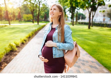 Beautiful Pregnant Girl Student, Happily Looks Into The Sky, Walks In The Park After Study.