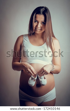 Woman in sports wear with earphones looking smartphone