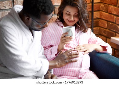 beautiful pregnant woman and black man discuss plans for future, want to be a good parents for baby, discuss all purchases they need - Powered by Shutterstock