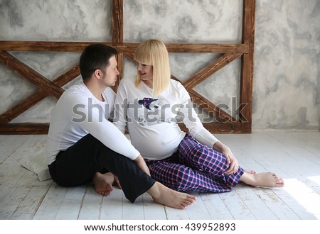 Beautiful pregnant woman in decoreted room with her husband