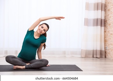 Beautiful Pregnant Woman Doing Exercise Indoors