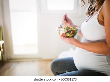 Beautiful Pregnant Woman Eating Healthy Food And Salads