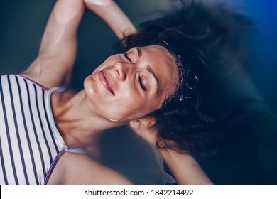 Beautiful Pregnant Woman Floating In Tank Filled With Dense Salt Water Used In Meditation, Therapy, And Alternative Medicine.