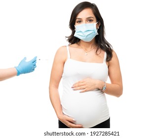 Beautiful Pregnant Woman In Her 30s Wearing A Face Mask And Getting The Coronavirus Vaccine During The Covid 19 Pandemic