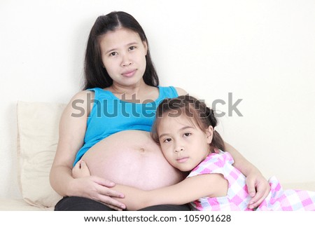 Similar – Image, Stock Photo Pregnant woman and little daughter in the rustic kitchen