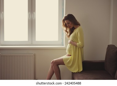 beautiful pregnant woman at home portrait