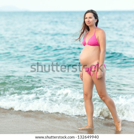 Beautiful pregnant woman on the beach