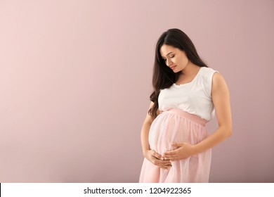 Beautiful Pregnant Woman On Color Background