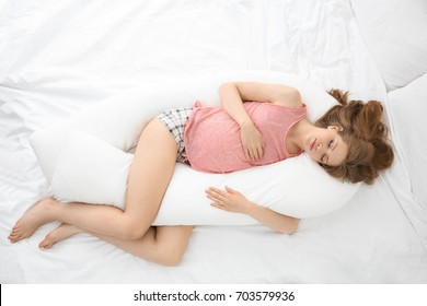 Beautiful Pregnant Woman Sleeping With Body Pillow