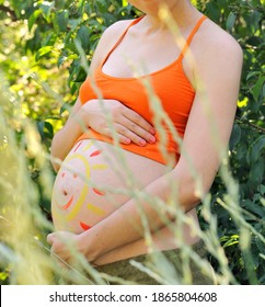 Beautiful pregnant woman tummy and sun drawing  no face
