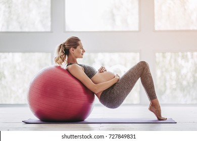 Beautiful Pregnant Woman Workout. Doing Yoga With Fitball.