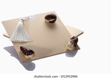 Beautiful  Premium Chocolate Sweets  Lie On A Holiday Envelope. Isolated On White Background. Full Sharpness Across The Entire Field Of The Frame.