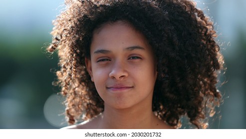 Beautiful preteen girl child portrait smiling outside, black African descent - Shutterstock ID 2030201732