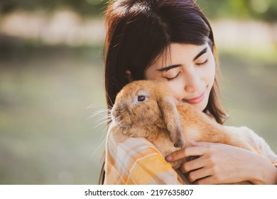 Beautiful Pretty Portrait Of Young Asian Woman Person With Cute Rabbit In Pet And Animal Care Concept, Happy Female Holding Bunny At Nature Outdoor Field With Friendship, Easter Concept