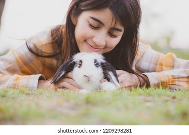 Beautiful Pretty Portrait Of Young Asian Woman Person With Cute Rabbit In Pet And Animal Care Concept, Happy Female Holding Bunny At Nature Outdoor Field With Friendship, Easter Concept