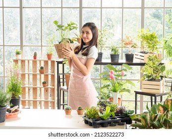 Beautiful pretty young Asian girl woman wearing white blouse with long black hair and beautiful, smiling with bright smile and looking small tree In tree planting room Happily and relaxed - Powered by Shutterstock