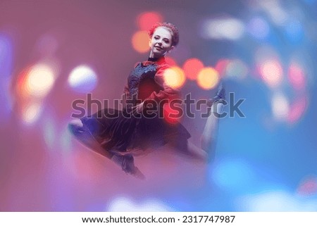 Beautiful professional dancer woman in national Irish costume makes a high jump during the dance. Studio full-length portrait. Traditional Irish dances.